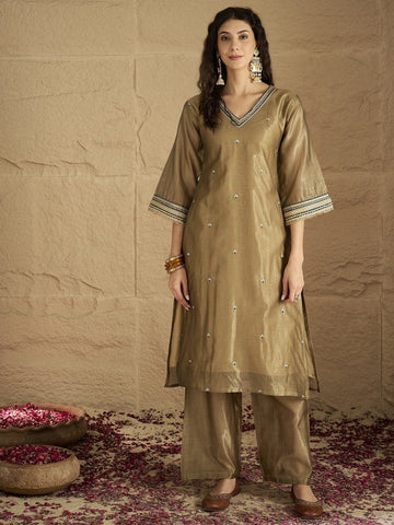 Varanga Women Radiate Festive Charm In This Gold Shimmer Kurta Set With Intricate Lace Detailing, Solid Ankle-Length Trousers, And  Printed Dupatta.